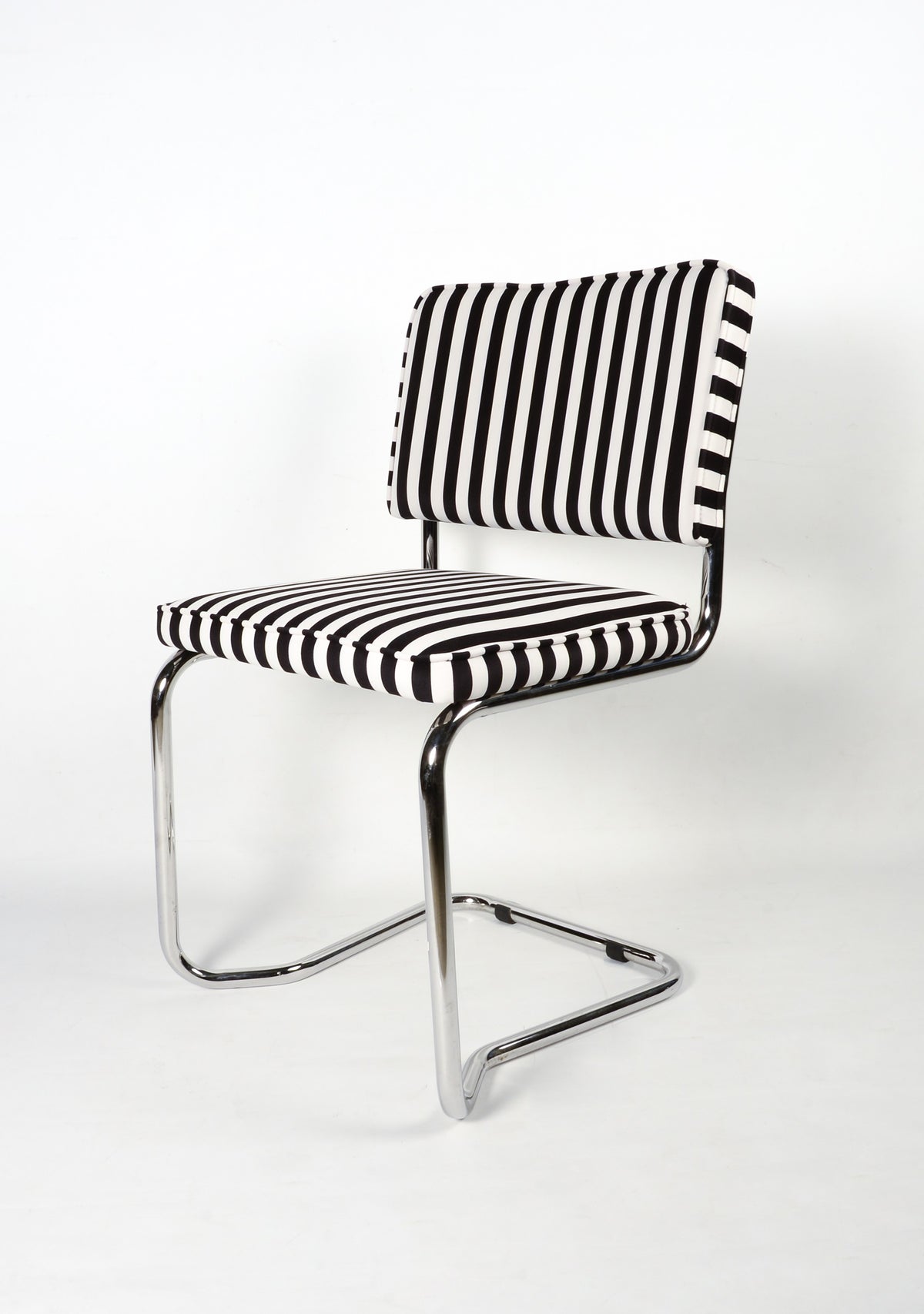 Upholstered chair in black and White striped velvet